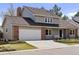 Charming two-story home featuring a brick and siding exterior, well-maintained lawn, and attached two-car garage at 7470 S Steele Cir, Centennial, CO 80122