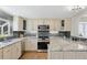 Modern kitchen boasts granite countertops, stainless steel appliances, and chic backsplash, perfect for culinary enthusiasts at 7470 S Steele Cir, Centennial, CO 80122
