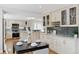 Spacious kitchen with stainless steel appliances, gray tile backsplash, granite countertops, and eat in table at 7470 S Steele Cir, Centennial, CO 80122