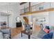Bright living room with hardwood floors, large windows, and an open floor plan leading to the dining area at 7470 S Steele Cir, Centennial, CO 80122