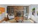 Cozy living room with a stacked stone fireplace and custom bookshelves, creating a warm and inviting atmosphere at 7470 S Steele Cir, Centennial, CO 80122