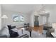 Inviting living room with hardwood floors, neutral color scheme, and abundant natural light from the large window at 7470 S Steele Cir, Centennial, CO 80122