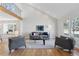 Open living space featuring vaulted ceilings, hardwood floors, and large windows allowing for ample natural light at 7470 S Steele Cir, Centennial, CO 80122
