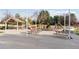 Outdoor playground area featuring slides, swings, and picnic tables under a shaded structure, great for Gathering fun at 7470 S Steele Cir, Centennial, CO 80122