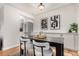 Dining room with a modern table, stylish chairs, updated lighting, and kitchen access at 1454 Jersey St # 104, Denver, CO 80220