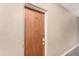 A solid wood door with classic brass hardware is labeled 