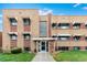 Charming brick apartment building with awnings, landscaping, and a welcoming entrance at 1454 Jersey St # 104, Denver, CO 80220