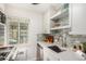 Modern kitchen with sleek countertops, stainless steel sink, and neutral backsplash at 1454 Jersey St # 104, Denver, CO 80220
