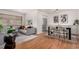 Open living space features a dining area, stainless steel appliances, and hardwood floors at 1454 Jersey St # 104, Denver, CO 80220