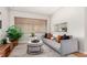 Bright living room with a comfortable couch, stylish ottoman, and large windows at 1454 Jersey St # 104, Denver, CO 80220