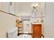 Cozy bathroom with a single sink vanity and shelf for storage at 2171 S Cherokee St, Denver, CO 80223