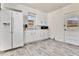 Functional kitchen with white cabinets, matching appliances, and a well-lit sink area at 2171 S Cherokee St, Denver, CO 80223