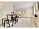 Open living space includes wood-look floors, casual dining, and bright natural light at 2171 S Cherokee St, Denver, CO 80223