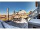 Backyard patio with an outdoor dining set, stone pavers, and views of surrounding scenery at 13437 Starhawk Ln, Parker, CO 80134
