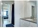 Bathroom with a sleek vanity, large mirror, and a doorway leading to a tiled shower area at 13437 Starhawk Ln, Parker, CO 80134