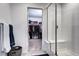 Modern bathroom featuring a glass-enclosed shower with a built-in seat and a walk-in closet at 13437 Starhawk Ln, Parker, CO 80134