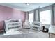 Cozy Bedroom featuring a crib, soft carpet, and a comfortable chair, creating a soothing atmosphere at 13437 Starhawk Ln, Parker, CO 80134