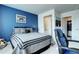 Tastefully designed bedroom with blue accent wall and ensuite bathroom with convenient closet access at 13437 Starhawk Ln, Parker, CO 80134