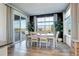 Bright dining room featuring wood floors, large windows, and a sliding glass door to a patio at 13437 Starhawk Ln, Parker, CO 80134