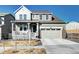 Beautiful two-story home features a covered front porch, a two-car garage and manicured landscaping at 13437 Starhawk Ln, Parker, CO 80134