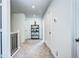 Well-lit hallway featuring neutral carpet, a decorative shelf, and access to multiple rooms at 13437 Starhawk Ln, Parker, CO 80134