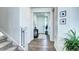 Bright hallway featuring hardwood floors and white walls leading to the front door at 13437 Starhawk Ln, Parker, CO 80134