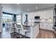 Bright kitchen featuring a large island, modern white cabinets, and stainless steel appliances at 13437 Starhawk Ln, Parker, CO 80134