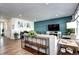 Cozy living room with hardwood floors, a teal accent wall, and ample natural light at 13437 Starhawk Ln, Parker, CO 80134
