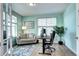 Light-filled office with a sofa, desk, and large windows providing natural light at 13437 Starhawk Ln, Parker, CO 80134