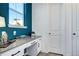 Stylish office nook with a gray countertop, white cabinets, and a window for natural light at 13437 Starhawk Ln, Parker, CO 80134