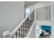 Elegant staircase with white banisters and black iron spindles, leading to the upper level at 13437 Starhawk Ln, Parker, CO 80134