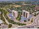 High-rise towers feature ample parking, a tennis court, and walking paths amid green trees and a neighborhood at 7877 E Mississippi Ave # 208, Denver, CO 80247
