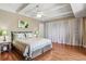 Bright bedroom with hardwood floors, ceiling fan, and charming decor creates a cozy and inviting space at 7877 E Mississippi Ave # 208, Denver, CO 80247
