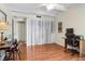 Bright bedroom featuring an open closet, wood floors, ceiling fan and desk area at 7877 E Mississippi Ave # 208, Denver, CO 80247