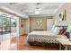 Bedroom with hardwood floors, access to balcony, and bright natural light at 7877 E Mississippi Ave # 208, Denver, CO 80247