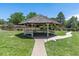 Community gazebo with seating on a well-maintained lawn at 7877 E Mississippi Ave # 208, Denver, CO 80247