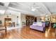 Spacious living room featuring hardwood floors, beamed ceilings, and a seamless flow into the dining area at 7877 E Mississippi Ave # 208, Denver, CO 80247