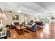 Spacious living room features hardwood floors, large windows, and ample seating at 7877 E Mississippi Ave # 208, Denver, CO 80247