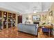 Inviting living room with hardwood floors, fireplace, and large built-in bookcase at 7877 E Mississippi Ave # 208, Denver, CO 80247