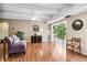 Bright living room with hardwood floors, access to the porch, and stylish accent furniture at 7877 E Mississippi Ave # 208, Denver, CO 80247