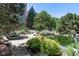 Peaceful pond and lounge chairs in a beautifully landscaped area at 7877 E Mississippi Ave # 208, Denver, CO 80247