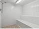 Tiled shower room with built-in seating and a modern shower head at 7877 E Mississippi Ave # 208, Denver, CO 80247