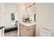 View from doorway into bathroom with modern vanity and bedroom with a view at 115 W 2Nd Ave # 101, Denver, CO 80223