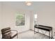 Bright bedroom with a large window, desk, and chair, perfect for relaxation and work at 115 W 2Nd Ave # 101, Denver, CO 80223