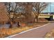 A paved bike path runs along a river with a bridge overhead, perfect for outdoor recreation at 115 W 2Nd Ave # 101, Denver, CO 80223