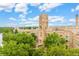 Beautiful building exterior surrounded by green trees and a vibrant blue sky at 115 W 2Nd Ave # 101, Denver, CO 80223