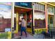 Charming café entrance with bright colors, inviting seating, and a view inside at 115 W 2Nd Ave # 101, Denver, CO 80223