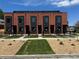 New brick townhouses with black trim and wrought iron fencing offer low-maintenance living with a contemporary look at 115 W 2Nd Ave # 101, Denver, CO 80223