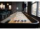 Inviting game room with shuffleboard table and seating, perfect for entertaining at 115 W 2Nd Ave # 101, Denver, CO 80223