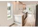 Contemporary kitchen featuring sleek countertops, modern appliances, and ample natural light at 115 W 2Nd Ave # 101, Denver, CO 80223